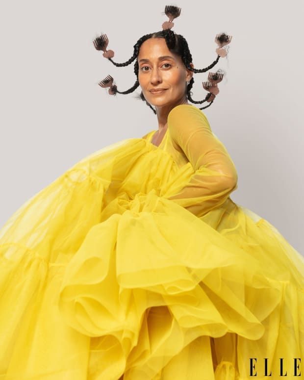 Tracee Ellis Ross on the cover of Elle magazine in a voluminous yellow dress and her hair in upturned plaits with small pick combs at the ends