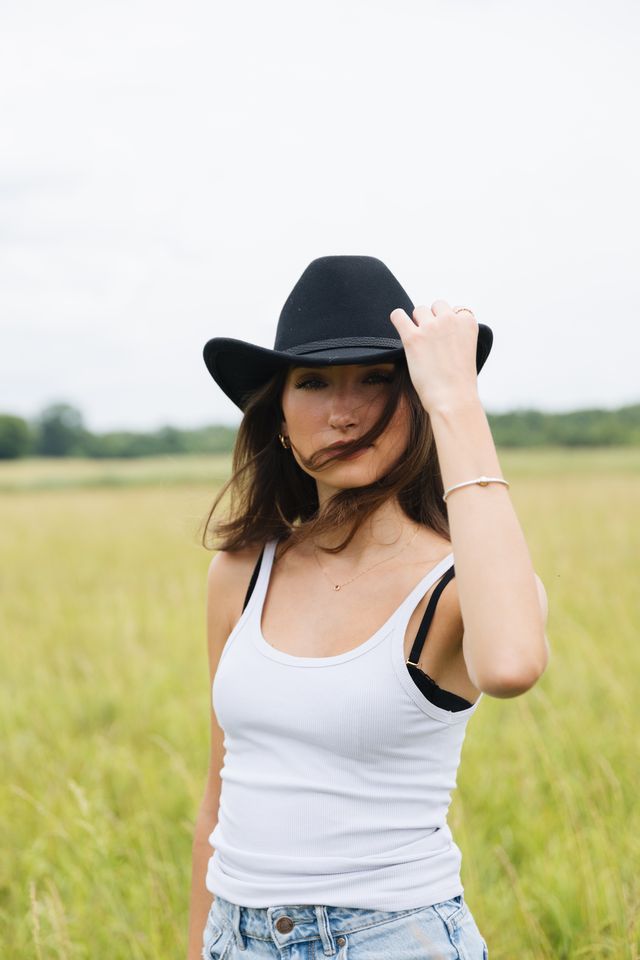 Erin Gibney holding her hat